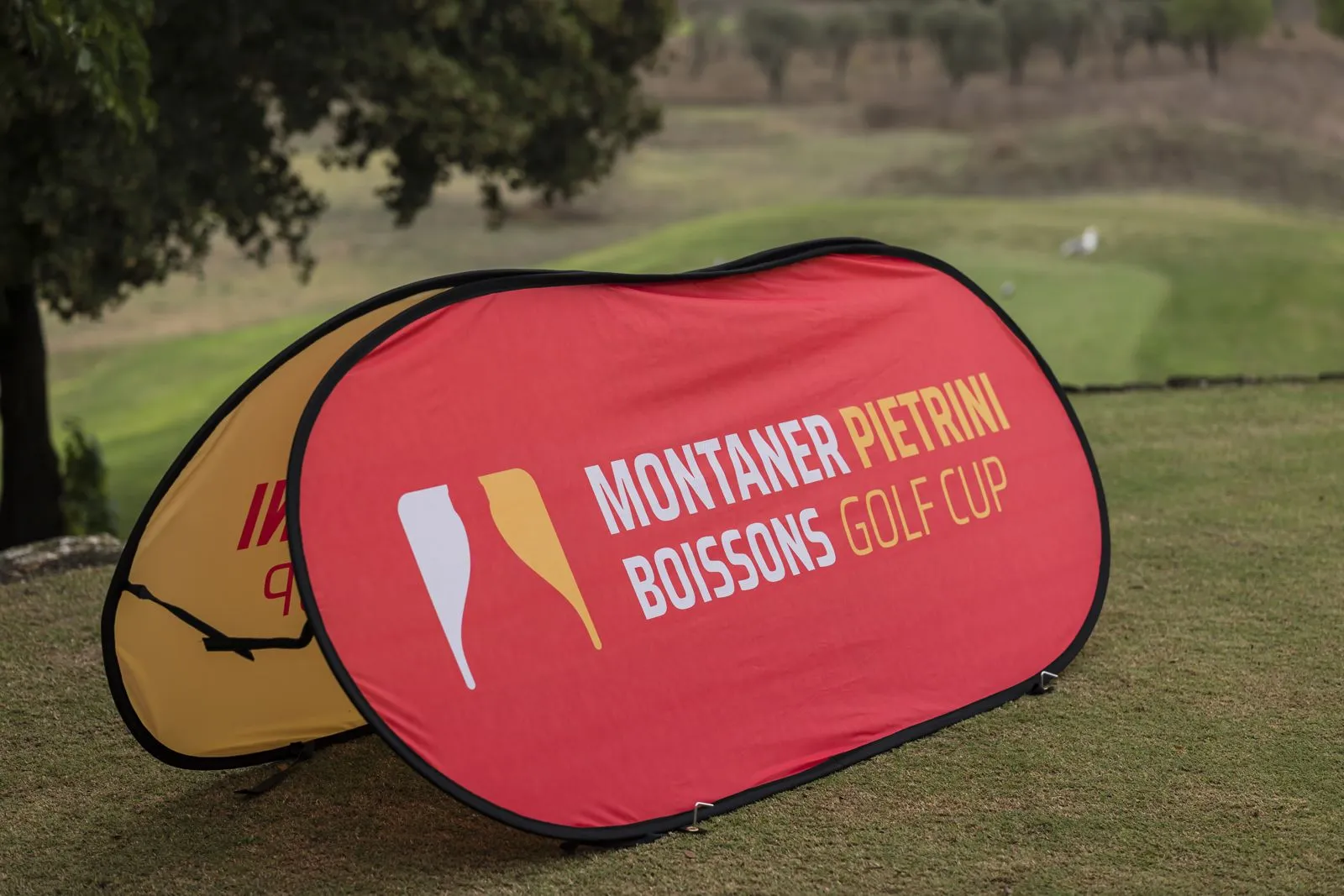 Panneau du partenaire de la compétition posé sur l'herbe du parcours