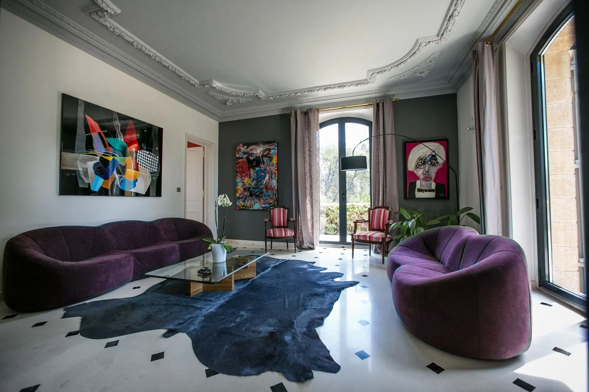 Salon aux fauteuils violets et moulures au plafond