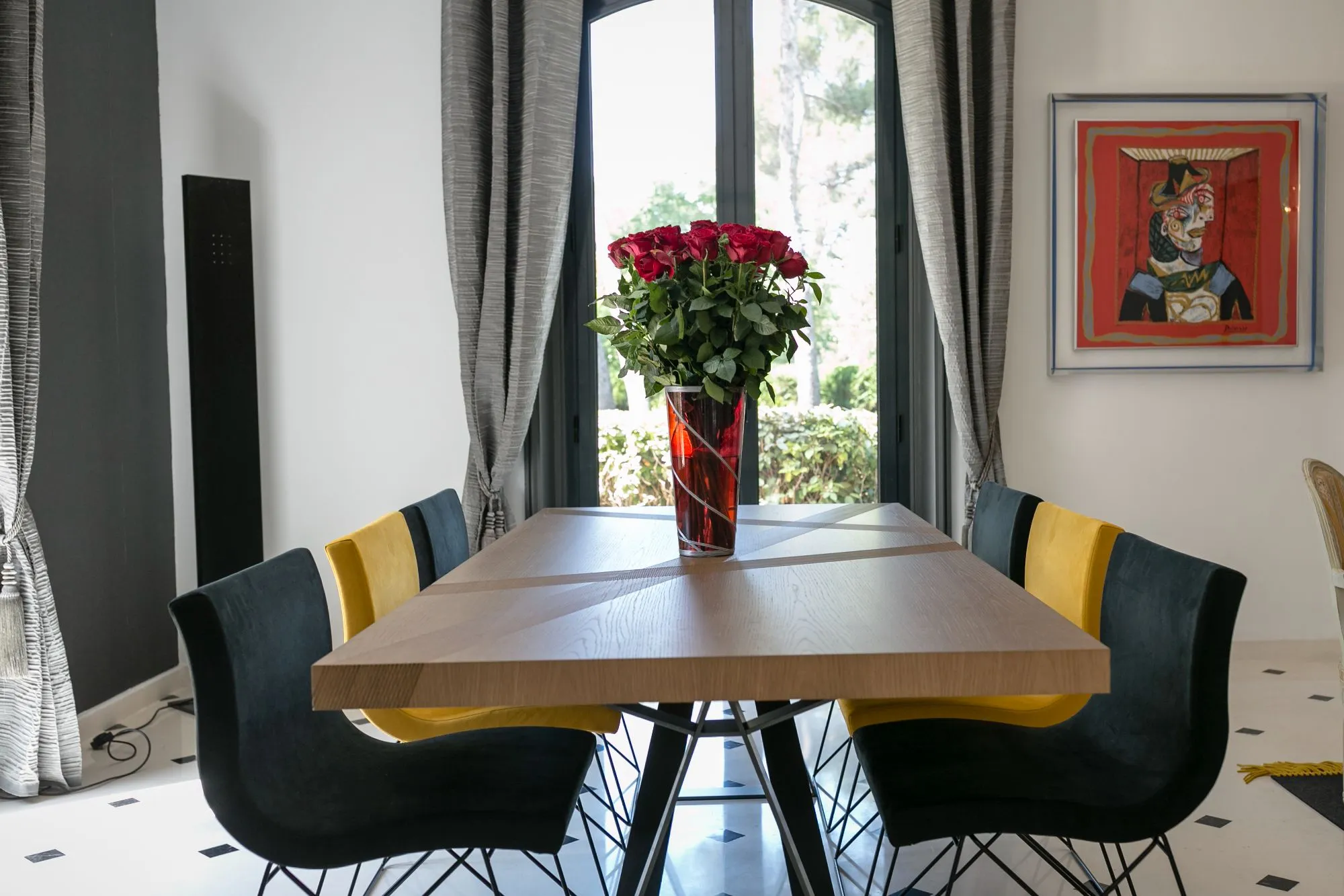 Salle à manger avec bouquet de roses et tableau coloré